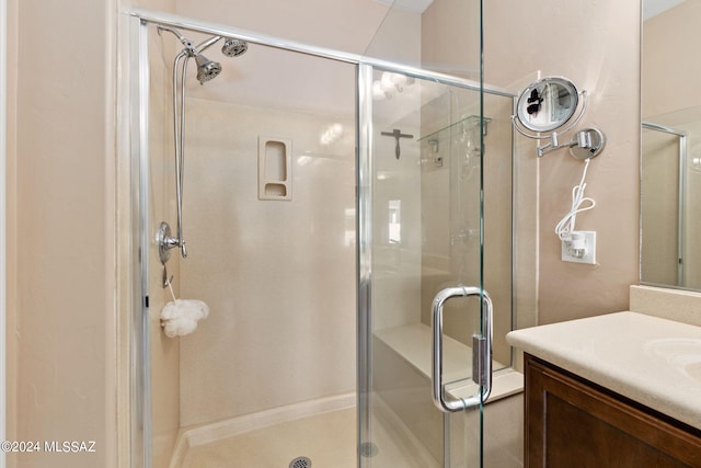 bathroom featuring walk in shower and vanity