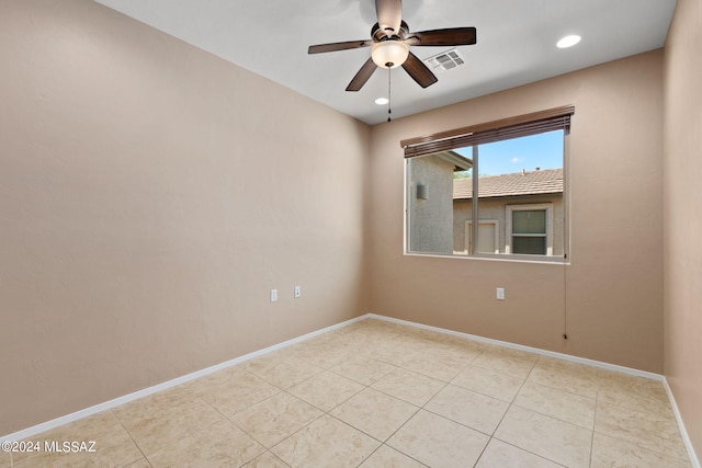 empty room featuring light tile patterned floors and ceiling fan