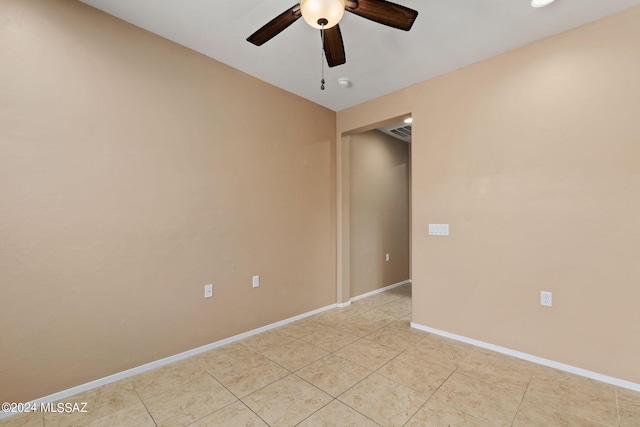 empty room featuring ceiling fan and light tile patterned floors