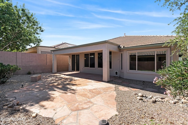 back of house with a patio