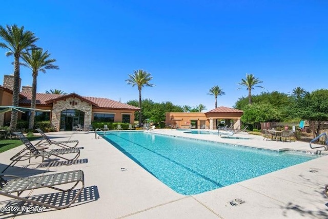 view of swimming pool featuring a patio area