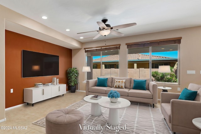 tiled living room with ceiling fan and plenty of natural light