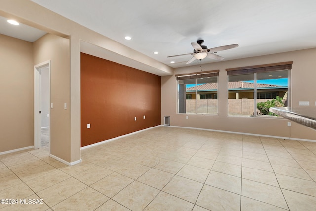 empty room featuring ceiling fan and light tile patterned floors