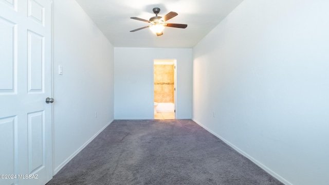 carpeted spare room featuring ceiling fan