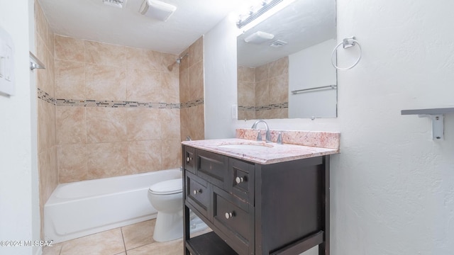 full bathroom with tile patterned floors, vanity, toilet, and tiled shower / bath combo