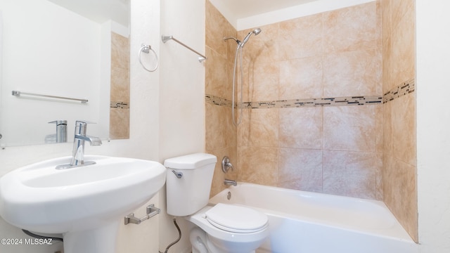 full bathroom with toilet, sink, and tiled shower / bath