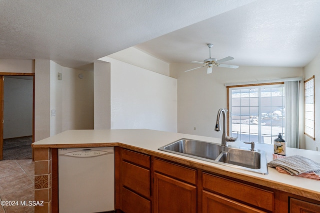 kitchen with ceiling fan, white dishwasher, sink, and a textured ceiling