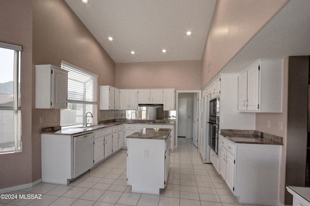 kitchen with a kitchen island, dishwasher, sink, white cabinets, and a high ceiling