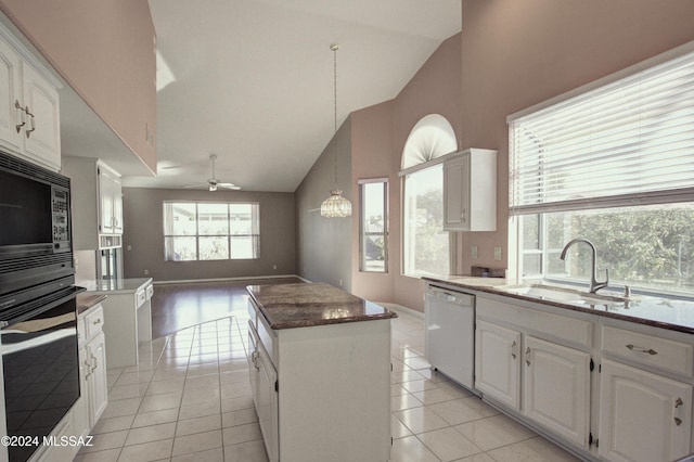 kitchen featuring sink, white cabinetry, a center island, appliances with stainless steel finishes, and pendant lighting