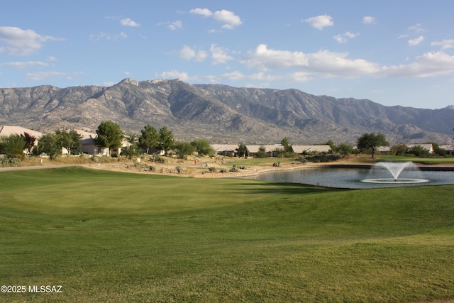 view of home's community featuring a water and mountain view and a lawn