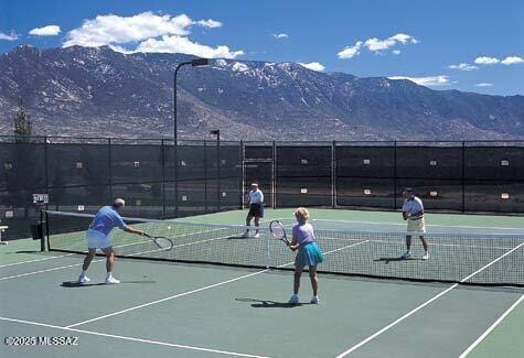 view of tennis court featuring a mountain view