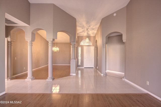 interior space with ornate columns and light hardwood / wood-style flooring