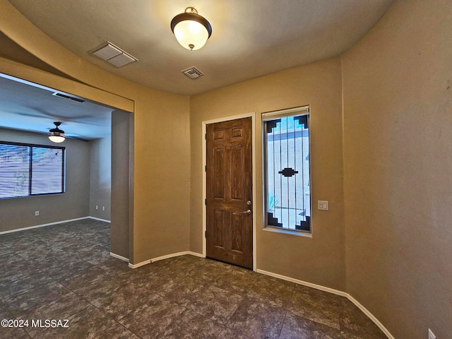 foyer with visible vents, ceiling fan, and baseboards