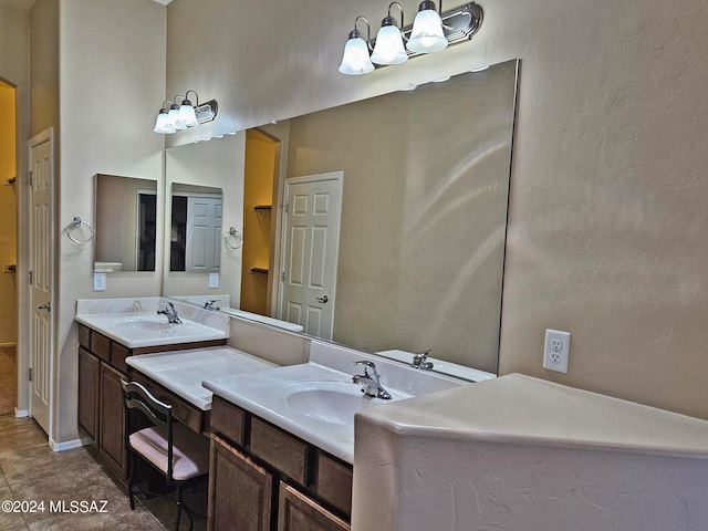 bathroom with tile patterned floors, a sink, and double vanity