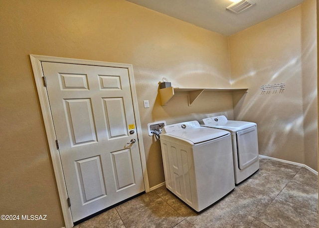 laundry area featuring laundry area, baseboards, visible vents, and washer and dryer