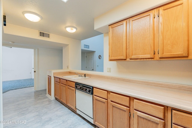 kitchen featuring dishwasher, light brown cabinets, and sink