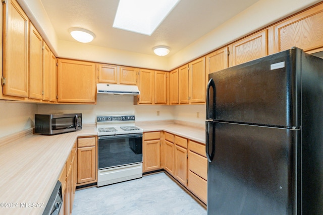 kitchen with a skylight, light brown cabinets, black fridge, and white range with electric stovetop