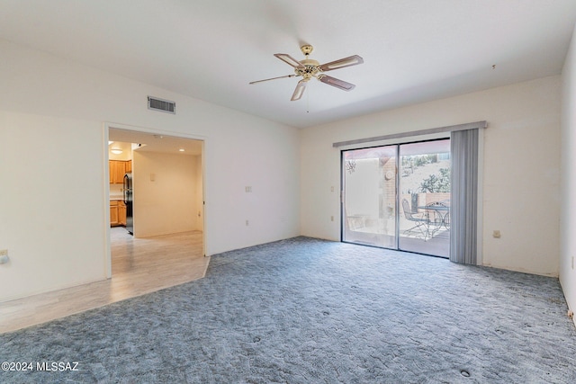 empty room featuring light hardwood / wood-style flooring and ceiling fan