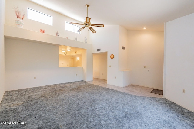 spare room with carpet floors, a high ceiling, and ceiling fan