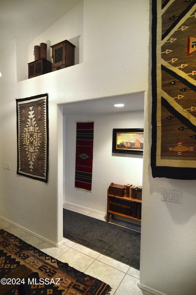 hall featuring light tile patterned floors