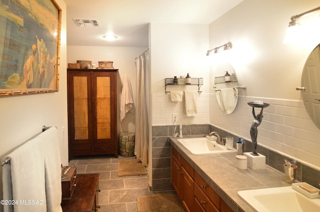 bathroom featuring vanity, tile walls, and tile patterned flooring