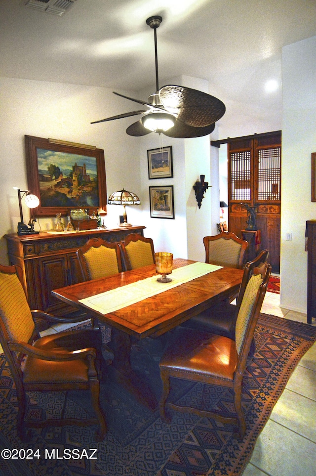 dining area featuring ceiling fan and light tile patterned flooring