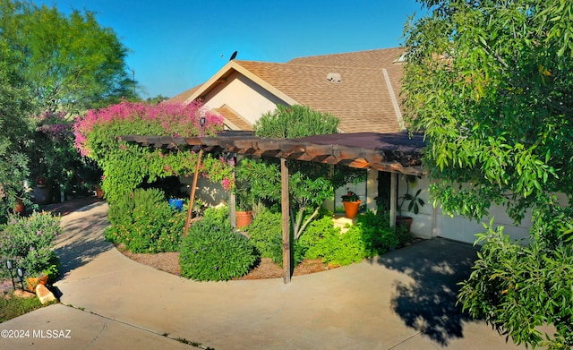 rear view of property featuring a patio and a pergola