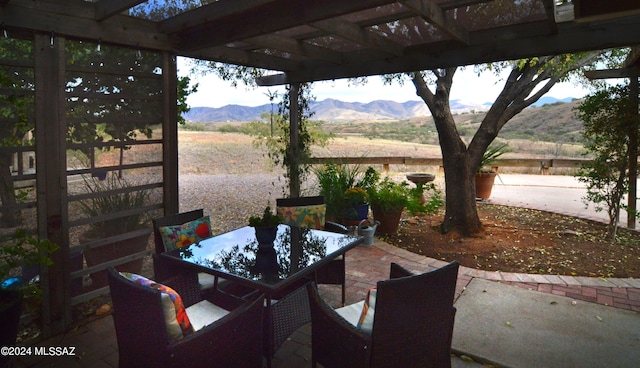 view of patio featuring a rural view, a mountain view, and a pergola