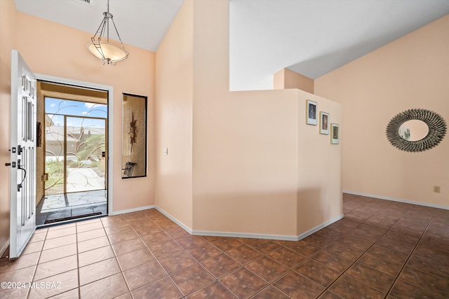 63156 E Flower Ridge Dr, Saddlebrooke, AZ 85739 - foyer with high vaulted ceiling, baseboards, and tile patterned floors