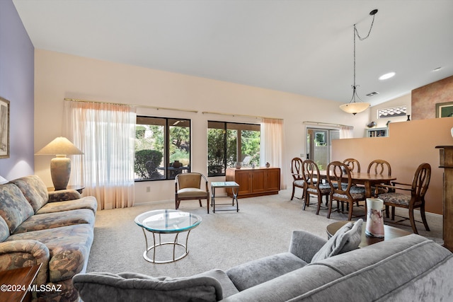 carpeted living room with vaulted ceiling