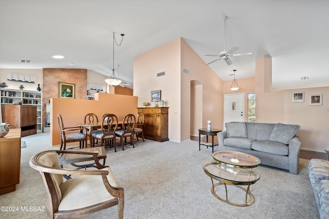 63156 E Flower Ridge Dr, Saddlebrooke, AZ 85739 - living room featuring light colored carpet, ceiling fan, arched walkways, high vaulted ceiling, and baseboards