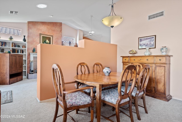 63156 E Flower Ridge Dr, Saddlebrooke, AZ 85739 - dining room with light carpet, lofted ceiling, ceiling fan, and baseboards