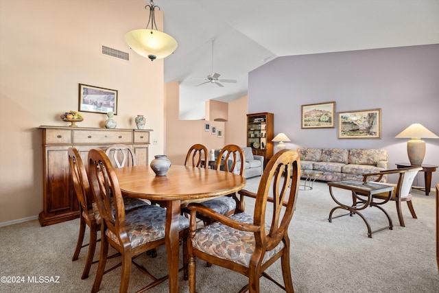 dining area with light carpet, vaulted ceiling, and ceiling fan