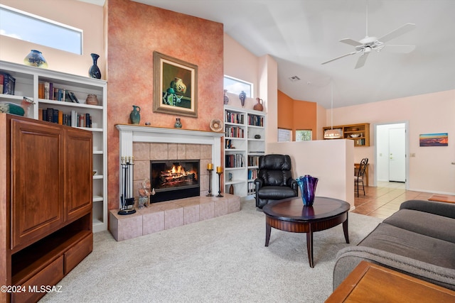 63156 E Flower Ridge Dr, Saddlebrooke, AZ 85739 - carpeted living area with a fireplace, ceiling fan, and high vaulted ceiling