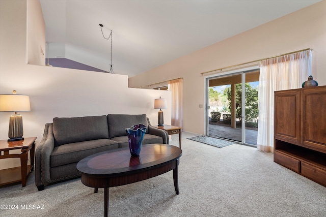 living room featuring light carpet and vaulted ceiling