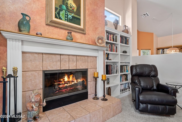 63156 E Flower Ridge Dr, Saddlebrooke, AZ 85739 - living area featuring a tile fireplace, carpet floors, and built in shelves