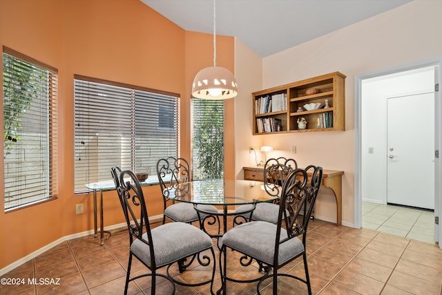63156 E Flower Ridge Dr, Saddlebrooke, AZ 85739 - dining room featuring light tile patterned floors, high vaulted ceiling, and baseboards