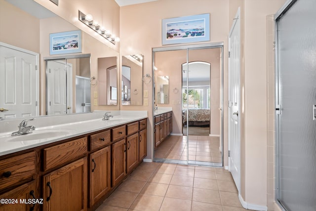 bathroom featuring walk in shower, vanity, and tile patterned flooring