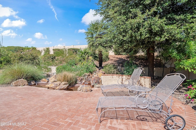 63156 E Flower Ridge Dr, Saddlebrooke, AZ 85739 - view of patio / terrace featuring outdoor dining space and fence