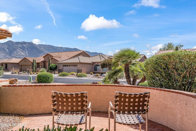 view of patio featuring a mountain view and a garage