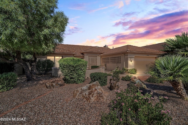 63156 E Flower Ridge Dr, Saddlebrooke, AZ 85739 - view of front of home featuring a garage, a tile roof, stucco siding, and a chimney