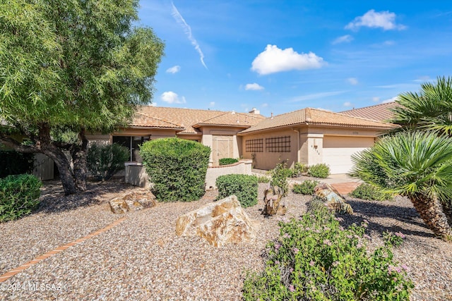 63156 E Flower Ridge Dr, Saddlebrooke, AZ 85739 - view of front of property featuring a tiled roof, stucco siding, and an attached garage