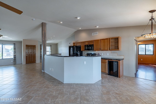 kitchen featuring ceiling fan, pendant lighting, beverage cooler, black appliances, and vaulted ceiling