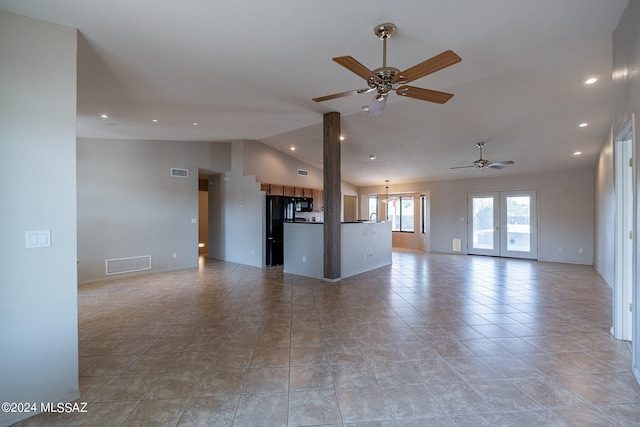 unfurnished living room with vaulted ceiling, ceiling fan, and light tile patterned flooring