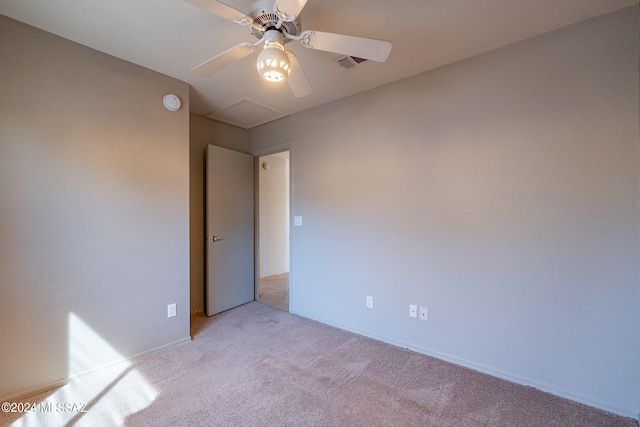 spare room featuring ceiling fan and light colored carpet