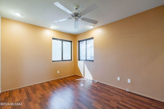 spare room featuring ceiling fan and dark hardwood / wood-style floors