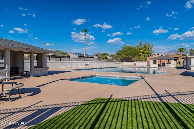 view of swimming pool with a yard and a patio