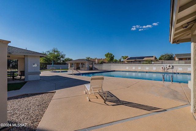 view of swimming pool with a patio