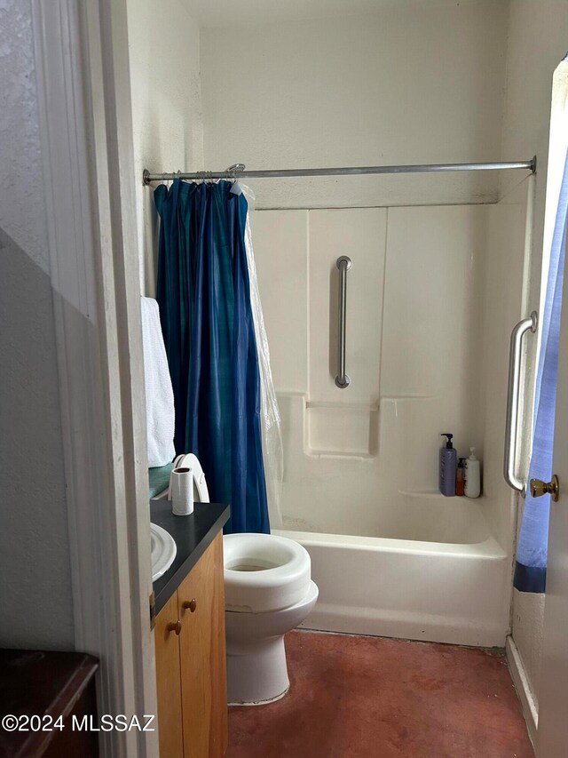 full bathroom with vanity, shower / tub combo, and toilet