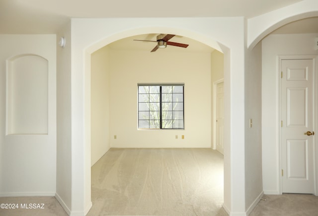 carpeted spare room with ceiling fan